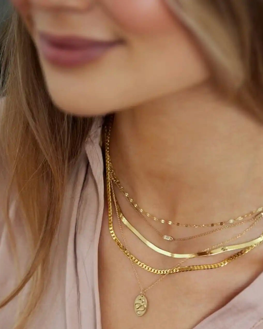 Layered gold necklaces styles on a model