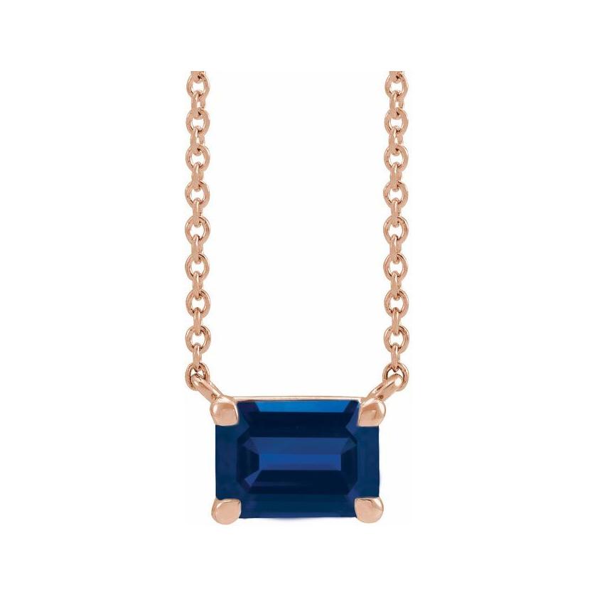 Emerald-cut sapphire birthstone necklace set in 14K rose gold with vertical minimalist pendant design