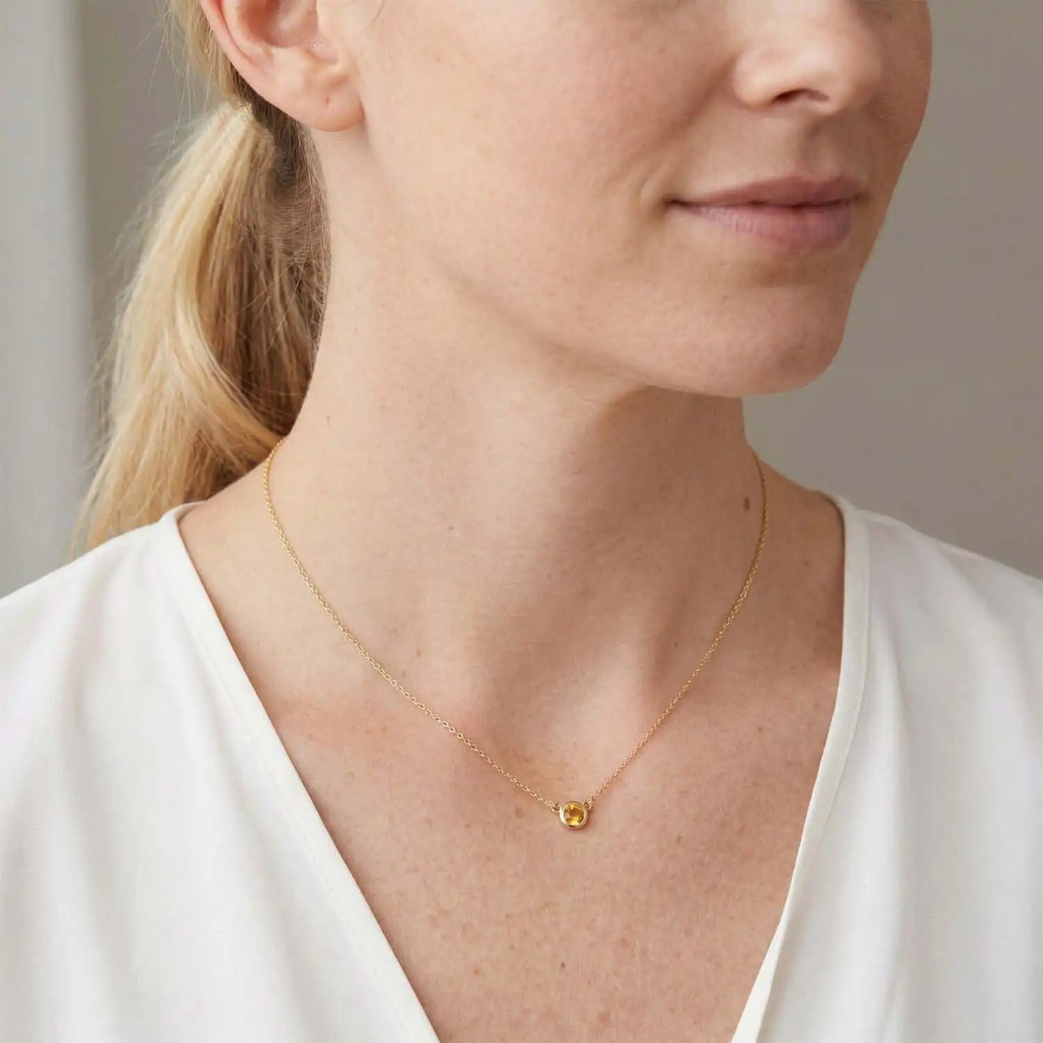 Bezel-set citrine necklace on model, layered at the collarbone variant--14K white gold