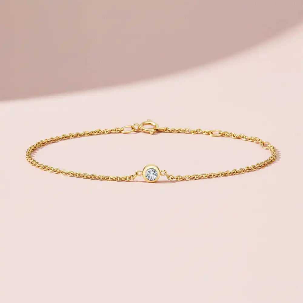 Bezel-set diamond birthstone bracelet. silver variant--14K-yellow-gold variant--Diamond
