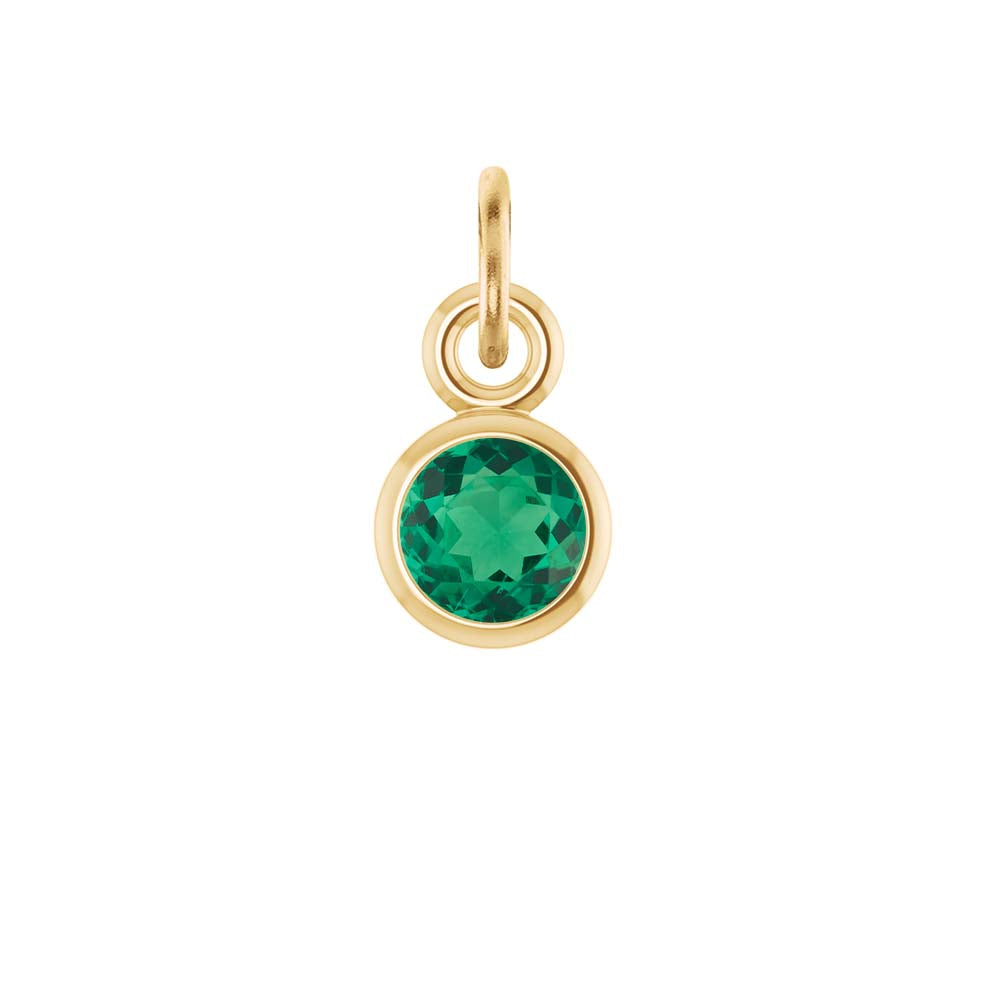 Delicate bezel-set emerald charm symbolizing May's birthstone in fine gold