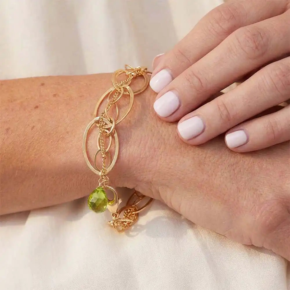 Natural peridot woven chain bracelet in sterling silver, close-up of setting in gold-fill variant--Gold-fill variant--Sterling-silver variant--Peridot