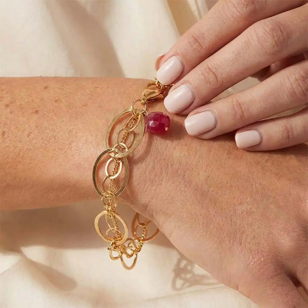 Natural ruby woven chain bracelet in sterling silver, close-up of setting in gold-fill variant--Gold-fill variant--Sterling-silver variant--Ruby
