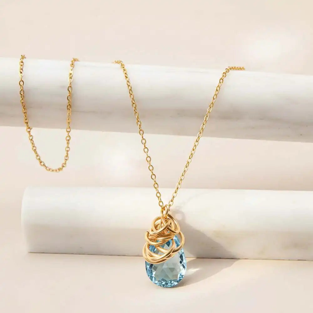 Natural swiss blue topaz pendant necklace in sterling silver, styled on chain necklace