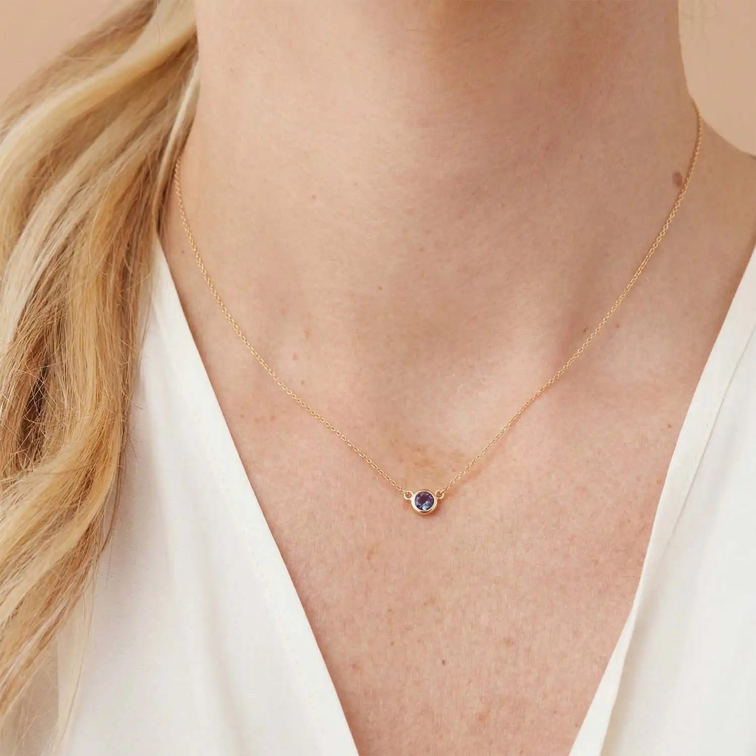 Bezel-set alexandrite necklace on model, layered at the collarbone variant--14K white gold