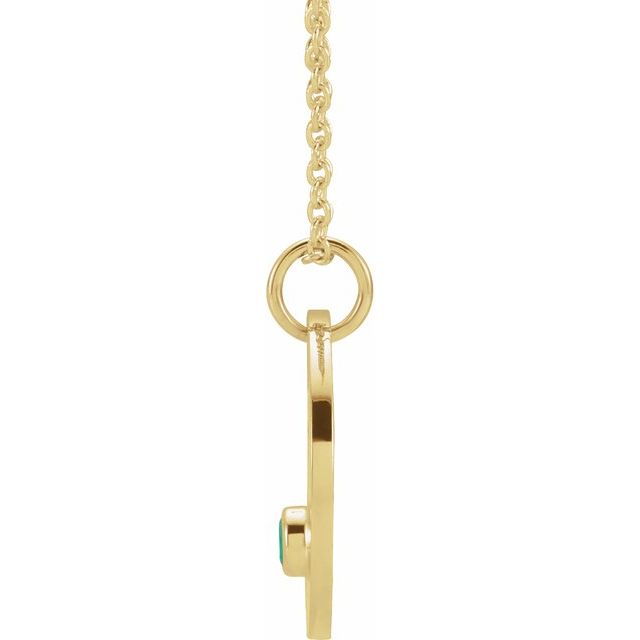 Aries zodiac necklace in 14K gold with vibrant emerald gemstone side view