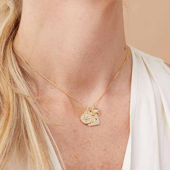3 cancer zodiac charms layered on chain styled on model