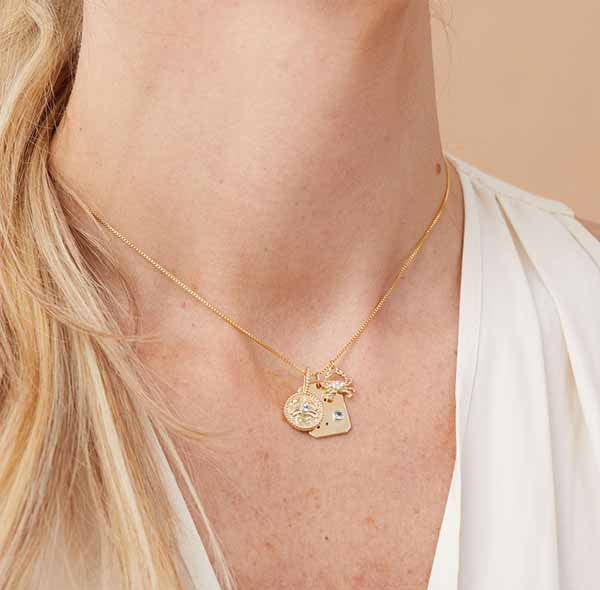 3 cancer zodiac charms layered on chain styled on model