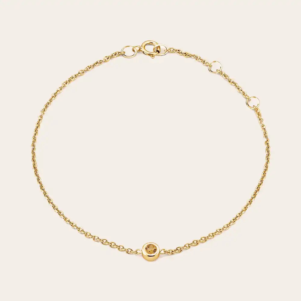 Bezel-set citrine bracelet flatlay showing warm golden stone on curb chain yellow gold variant--14K-yellow-gold variant--Citrine