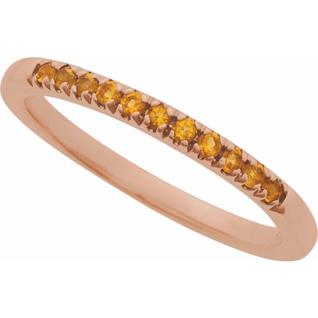 Rose gold birthstone stacking ring glowing with warm citrine gems