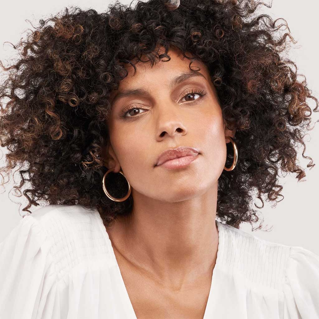 Classic bold gold hoop earrings styled for everyday wear