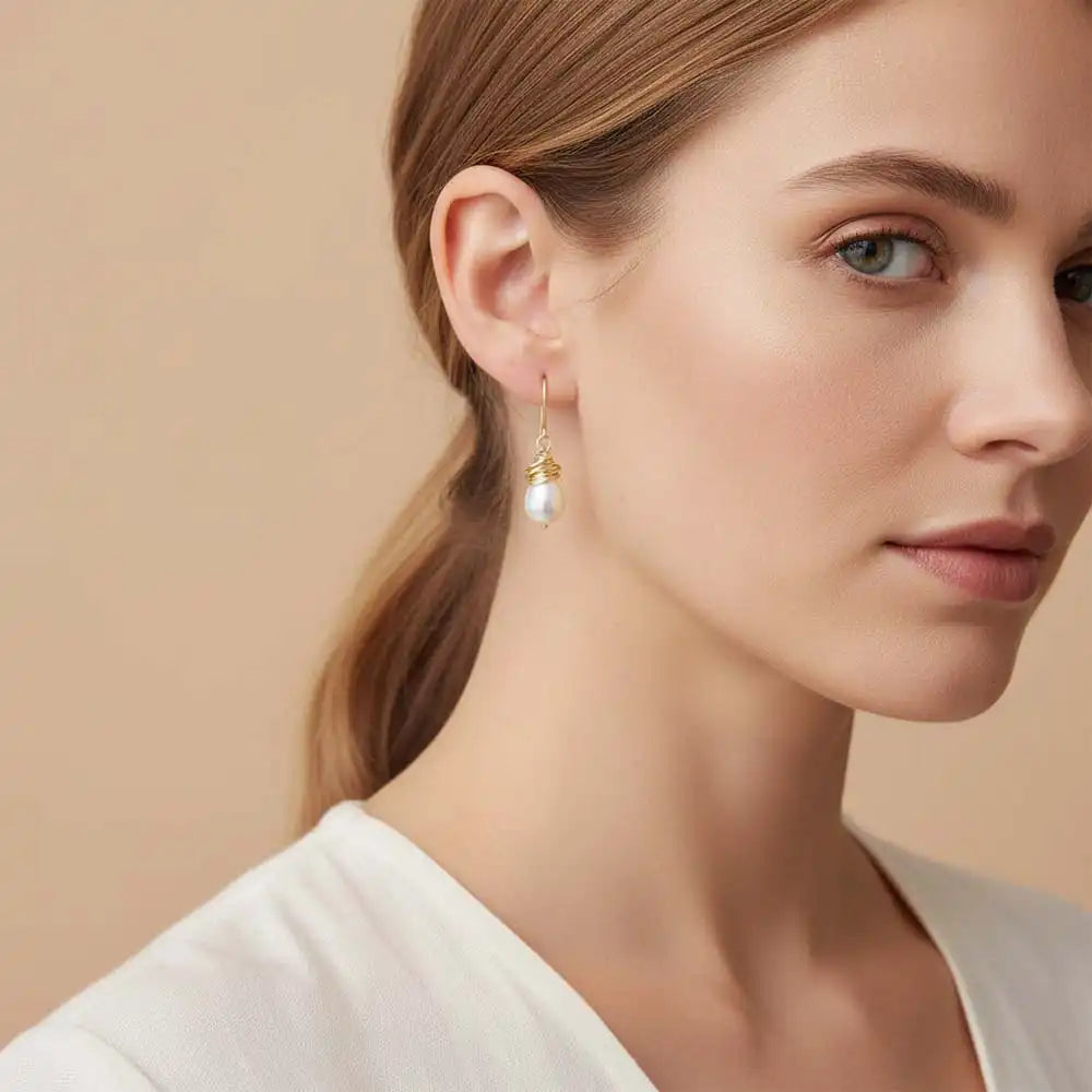 Close-up of natural pearl bezel dangle earring, showing iridescent luster and handcrafted wire detail variant--Gold-fill variant--Sterling-silver variant--Pearl