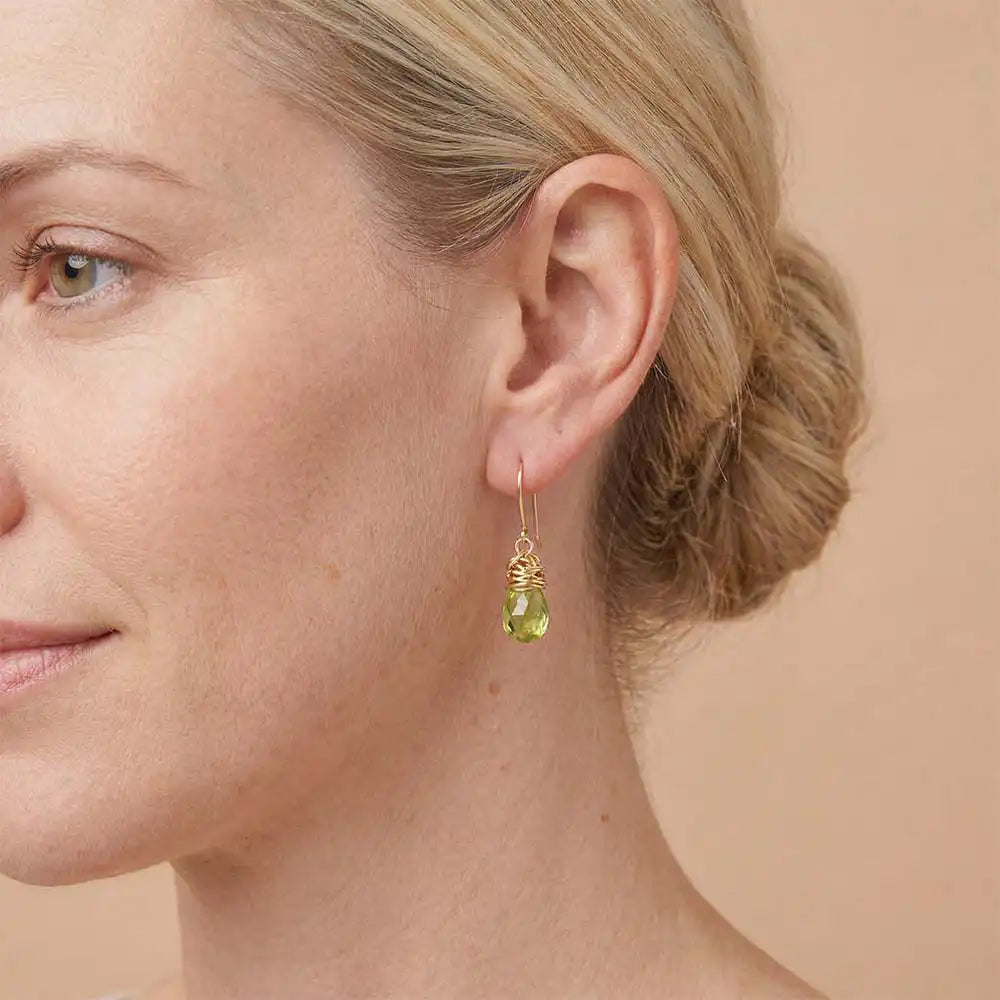 Close-up of natural peridot bezel dangle earring, showing bright green stone and handcrafted wire detail variant--Gold-fill variant--Sterling-silver variant--Peridot
