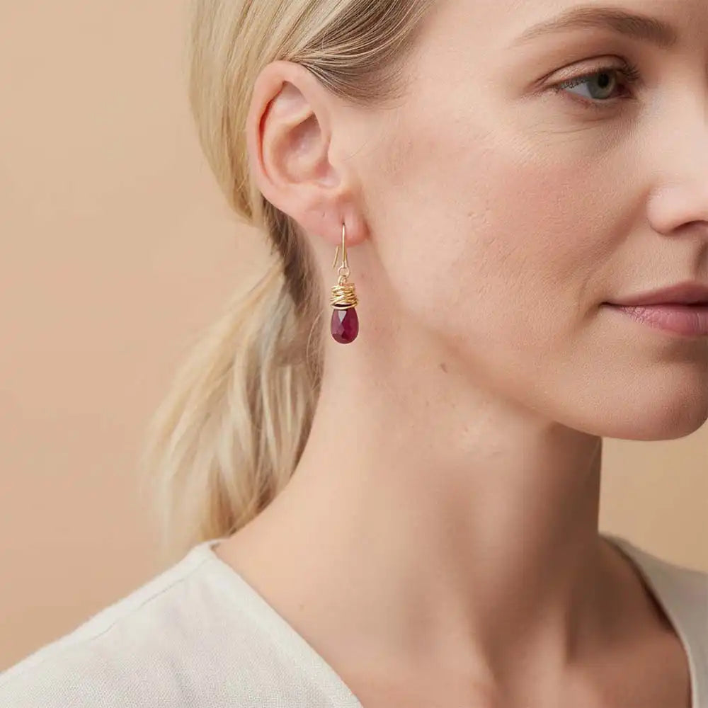 Close-up of natural ruby bezel dangle earring, showing rich red stone and handcrafted wire detail variant--Gold-fill variant--Sterling-silver variant--Ruby