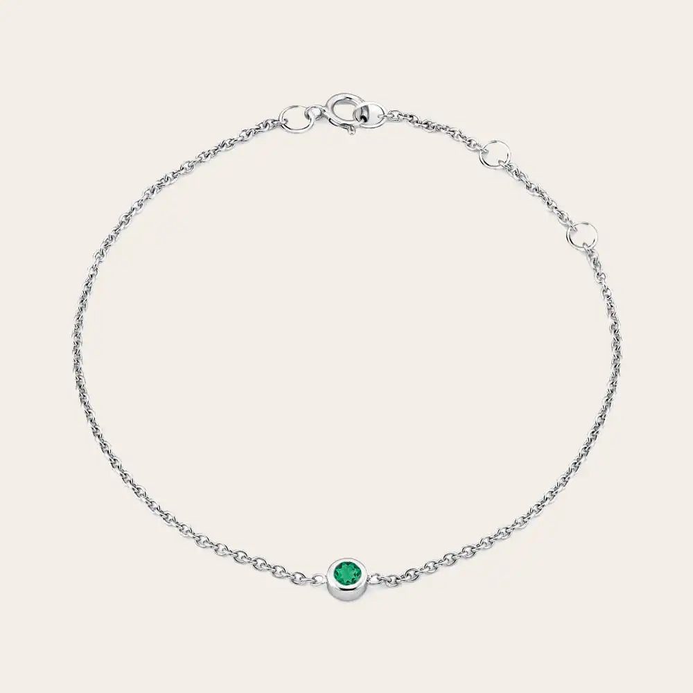 Bezel-set emerald bracelet in 14K white gold, close-up of green stone in bezel rose white variant--14K-white-gold variant--Emerald