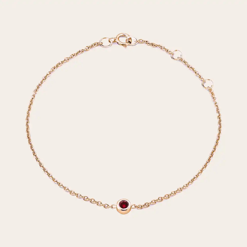Bezel-set garnet bracelet in 14K rose gold, close-up of red stone in bezel variant--14K rose gold