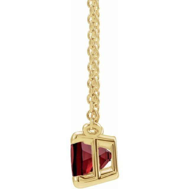 Side view of garnet necklace on gold chain with spring-ring clasp