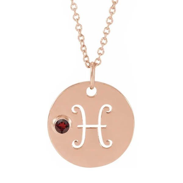 14K rose gold zodiac charm necklace for Pisces, paired with a natural garnet.