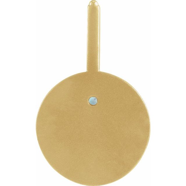 Gold circular object with a small blue gemstone on a white background