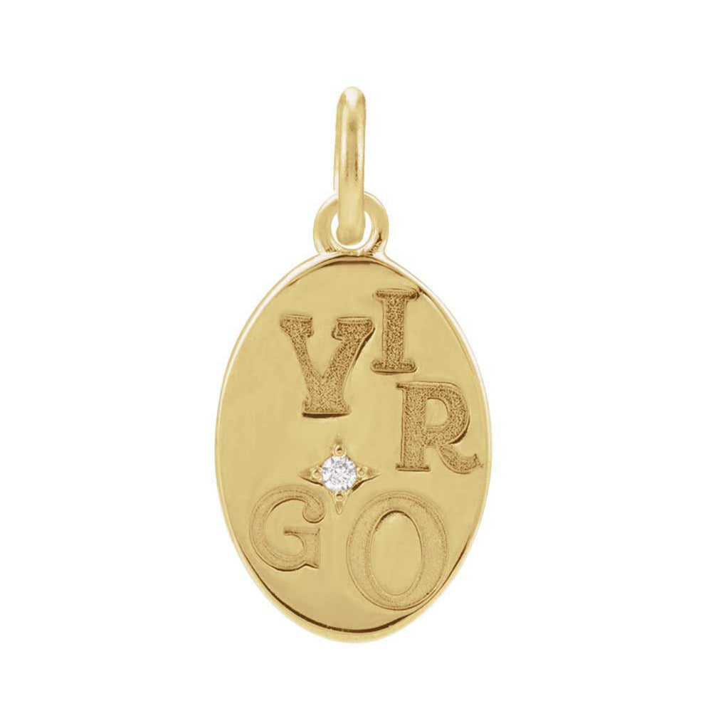 Close-up of Virgo symbol engraved on recycled gold charm