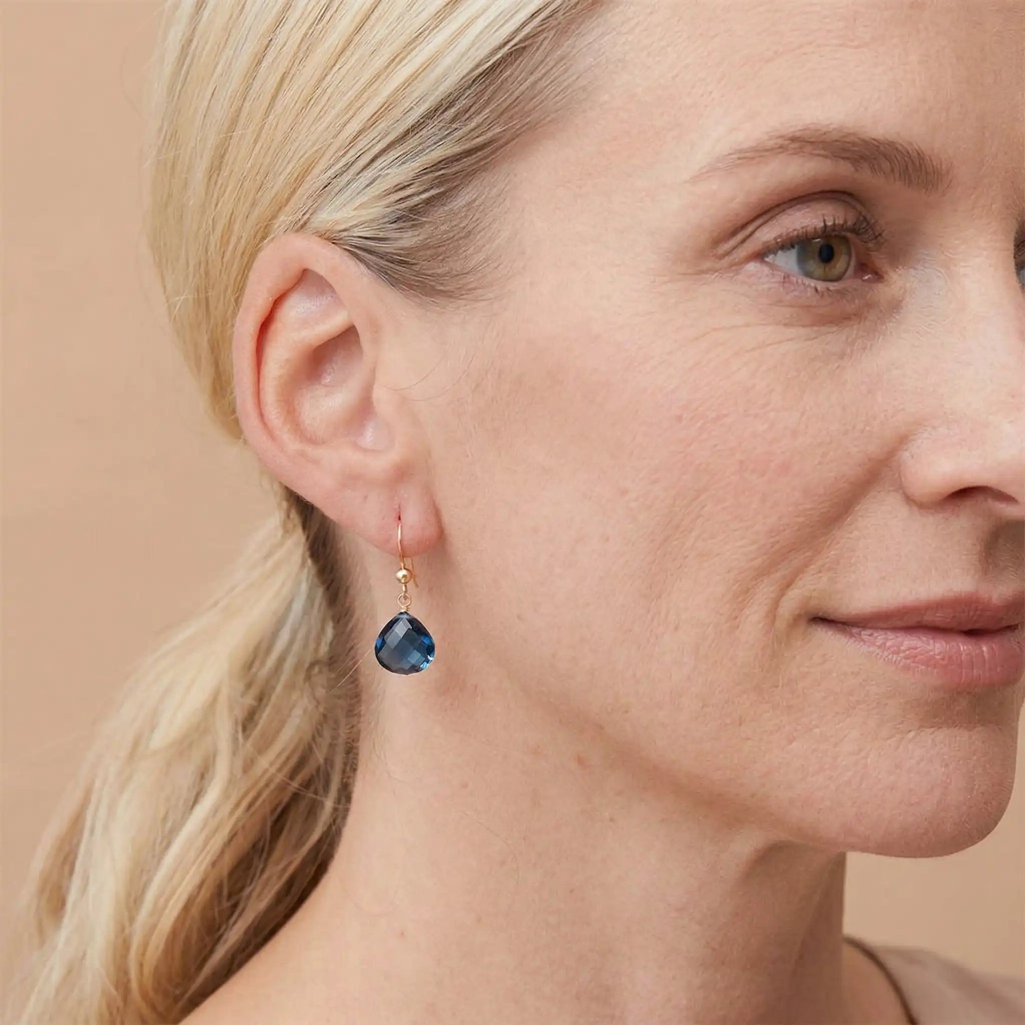 Drop earring in gold-fill shown on model. variant--Gold-fill, variant--Sterling-silver, variant--14K-yellow-gold, variant--14K-white-gold variant--London-Topaz