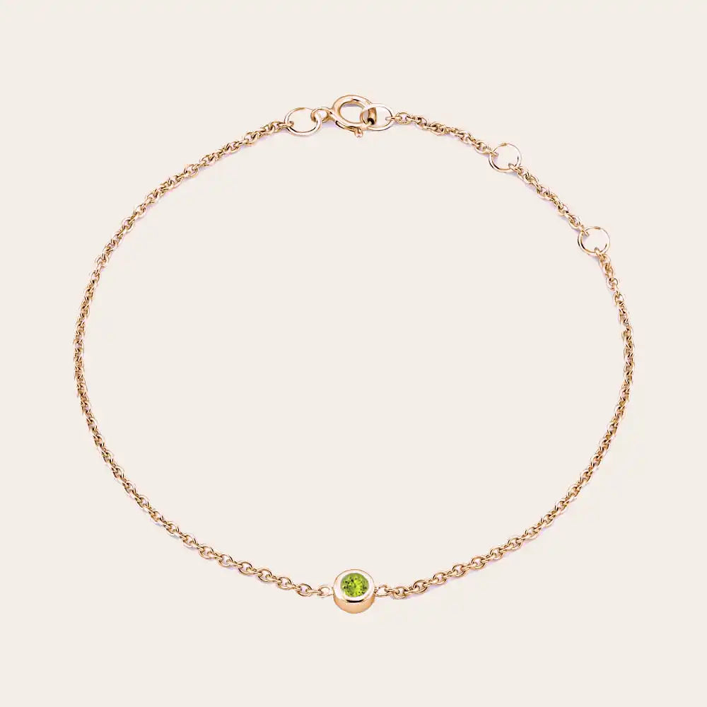Bezel-set peridot bracelet in 14K rose gold, wrist view on model rose gold variant--14K-rose-gold
