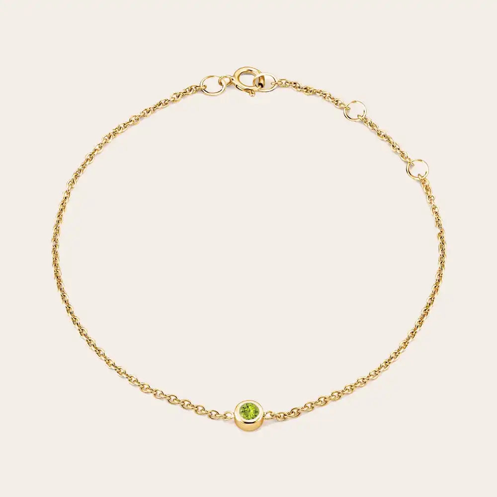 Bezel-set peridot bracelet in yellow gold, close-up of stone setting yellow gold variant--14K-yellow-gold variant--Peridot