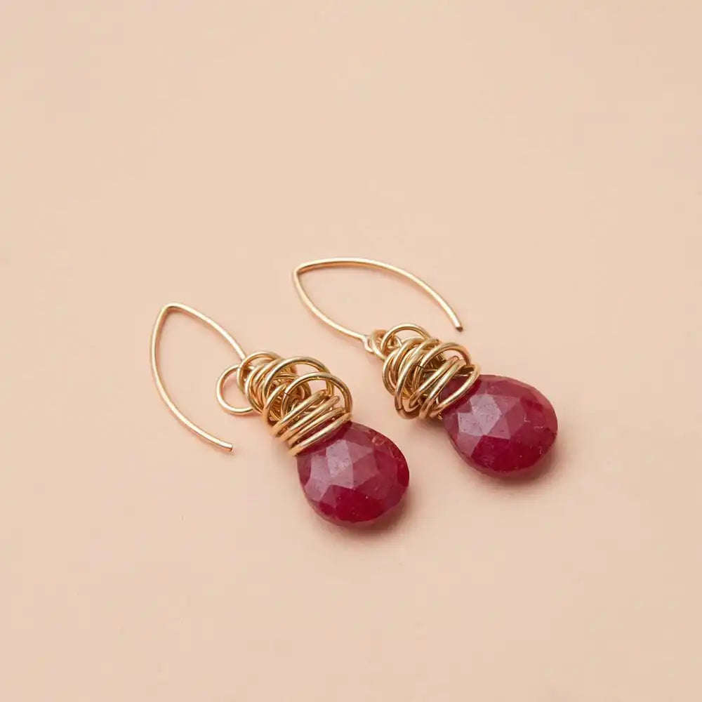 Ruby dangle earrings product shot, genuine deep red stone in sculptural bezel setting on model variant--Gold-fill variant--Sterling-silver variant--Ruby