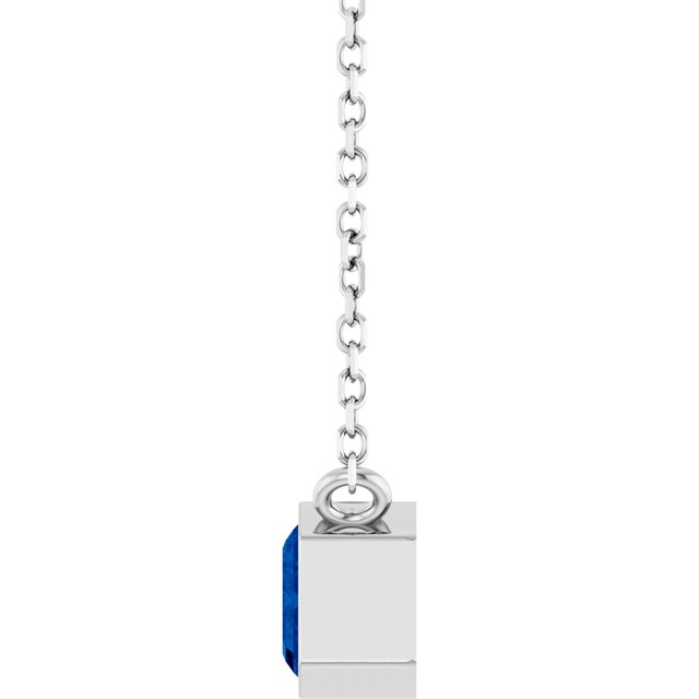 Close-up of sapphire necklace with horizontal emerald cut side view