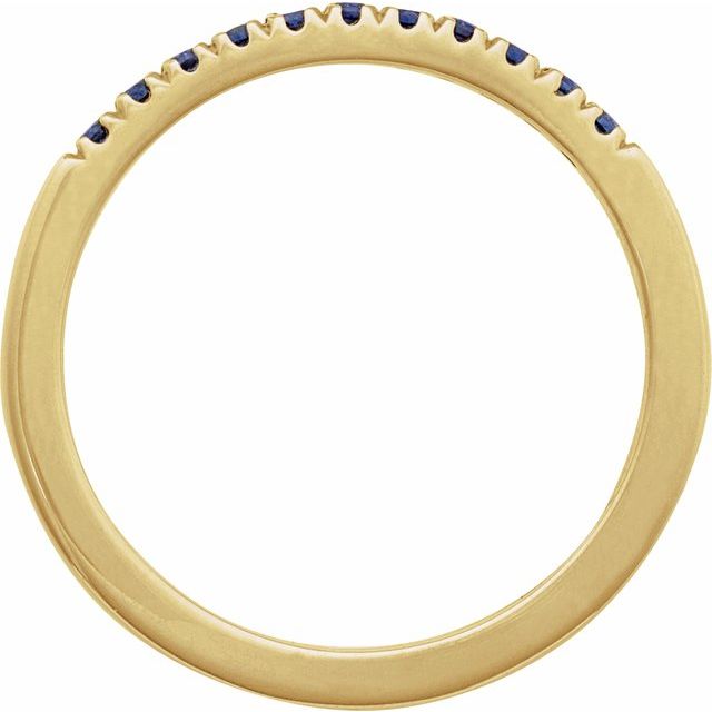Side view of blue sapphire stacking ring in yellow gold