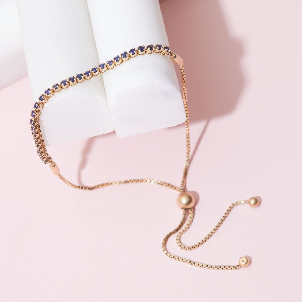 Adjustable tennis bracelet with rich blue sapphires set in polished 14K gold