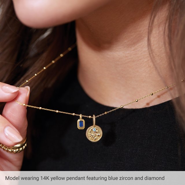 Layered Scorpio medallion charm necklace styled with chains