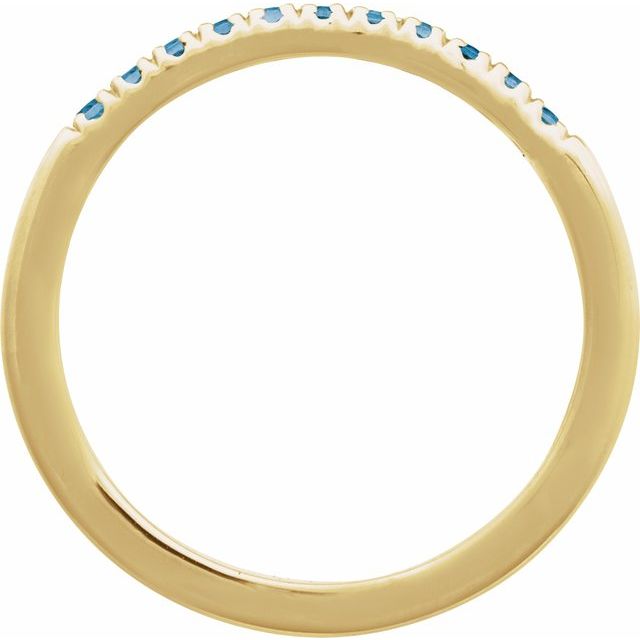 Close-up of Swiss blue topaz stacking ring in 14K yellow gold