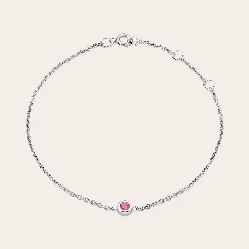 Model wearing bezel-set birthstone bracelet. variant--14K rose gold