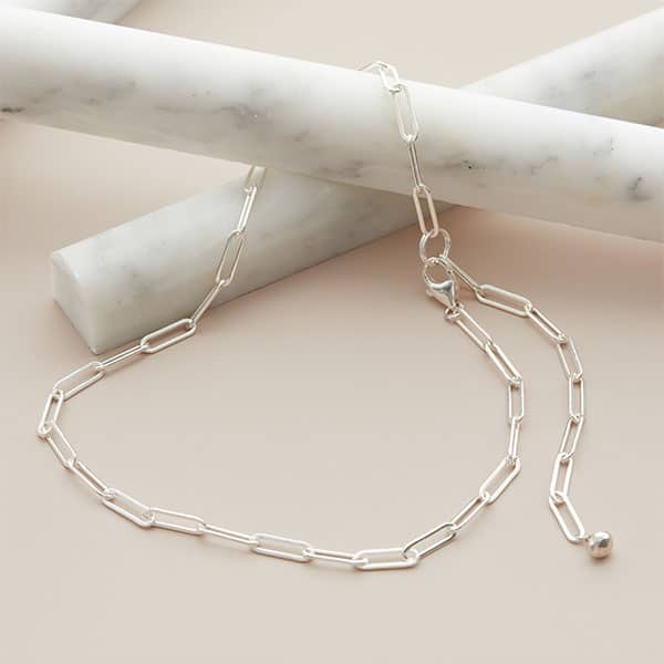 Sterling silver paperclip chain necklace, artfully handmade in the USA, shown styled as a modern layering piece.