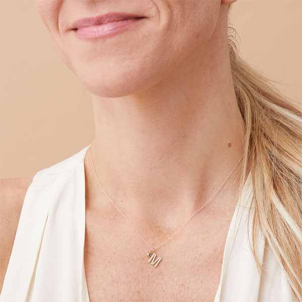 Handcrafted gold letter necklace with round birthstones for moms on model