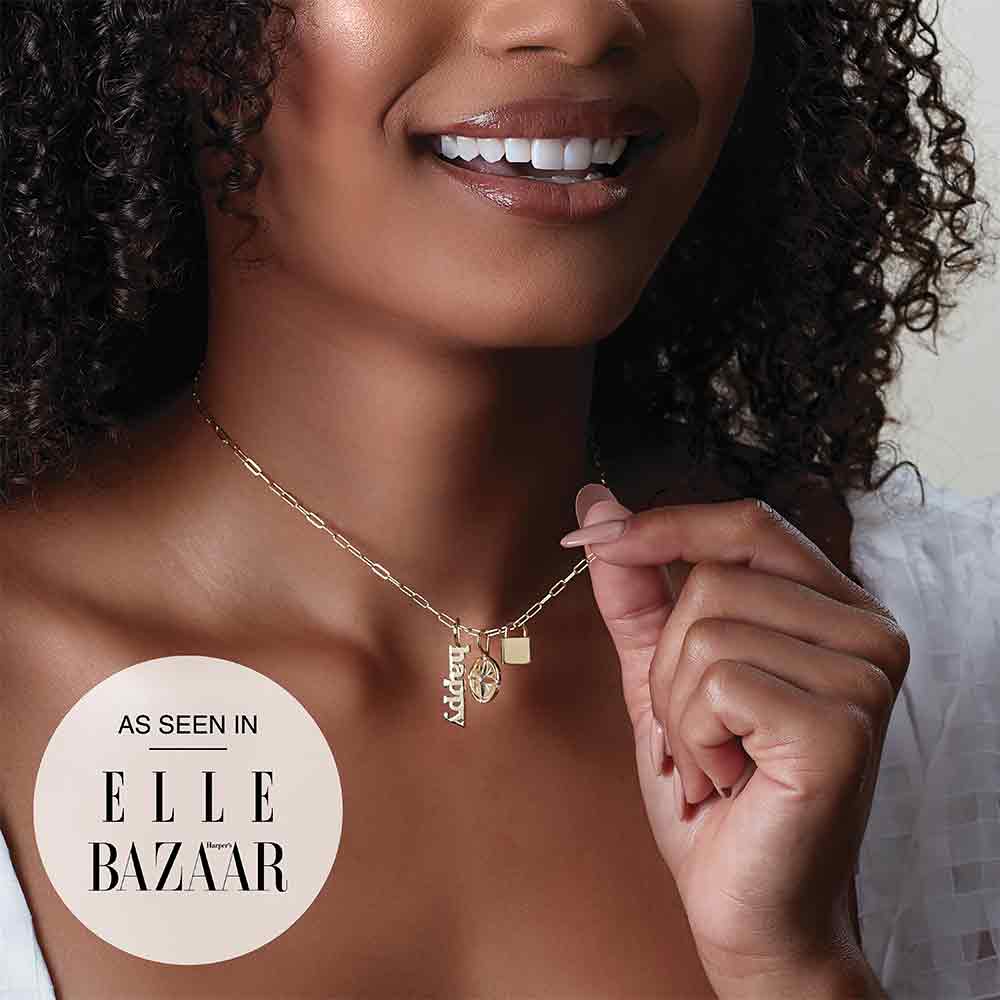 Engraved gold lock necklace with initials and charms on model