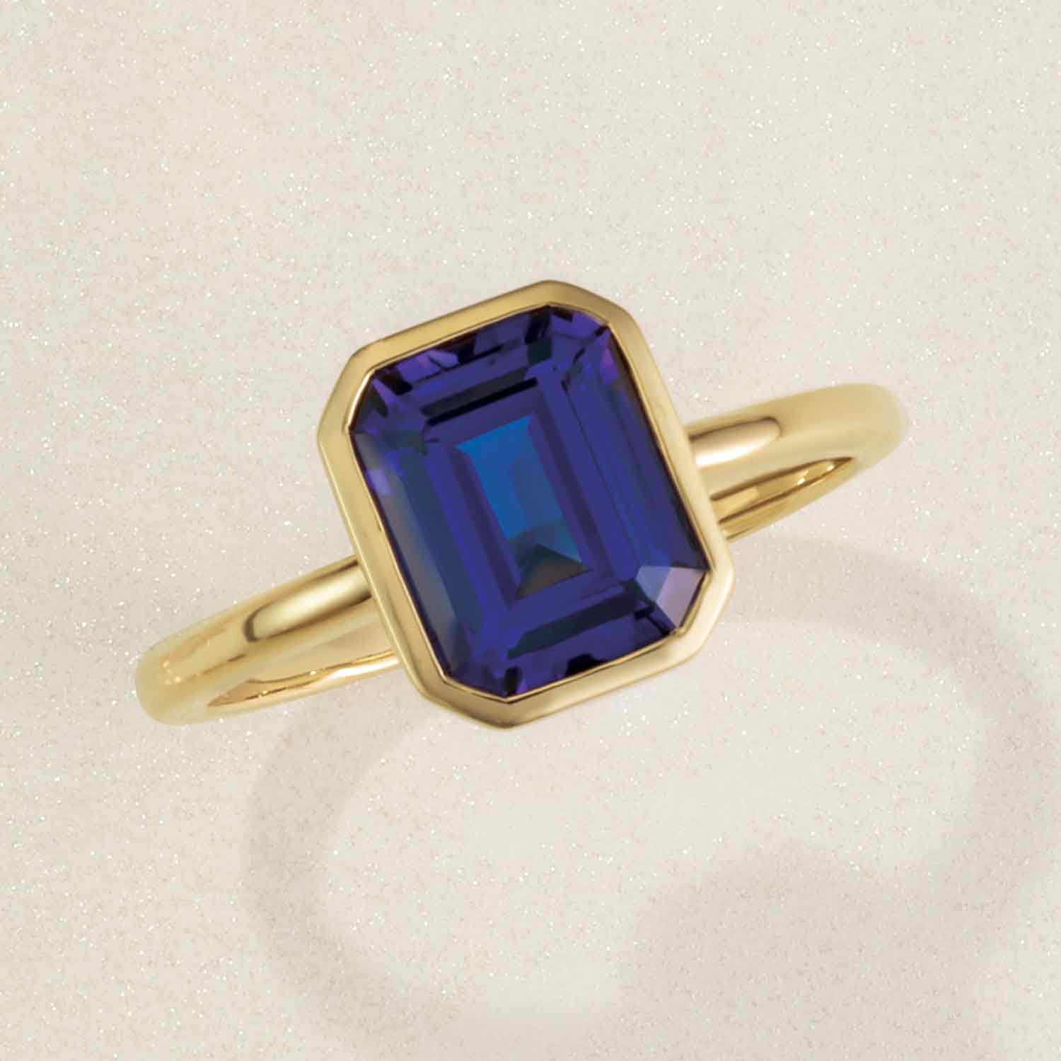 Sapphire rings collection.  Emerald-cut sapphire cocktail ring in uellow gold