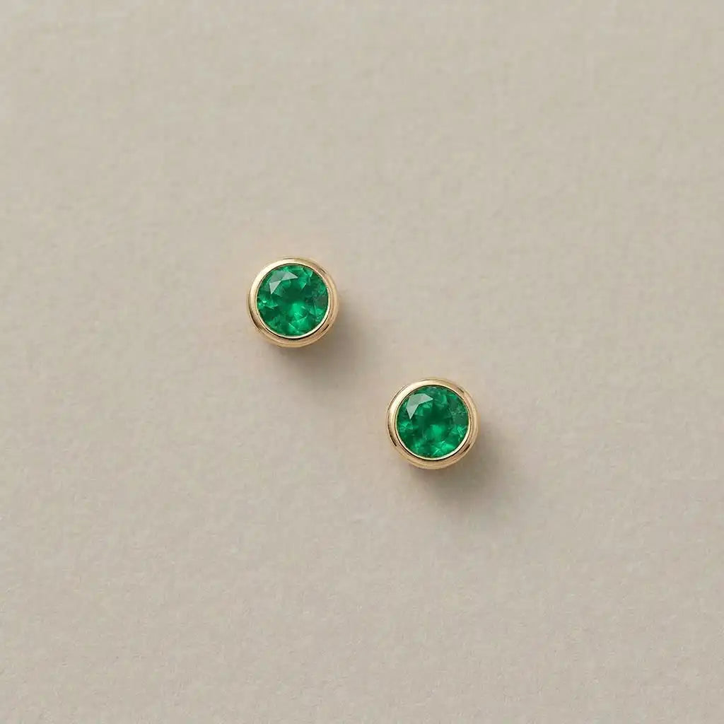 Emerald stud earrings in 14K yellow gold handmade by Erin Gallagher Jewelry