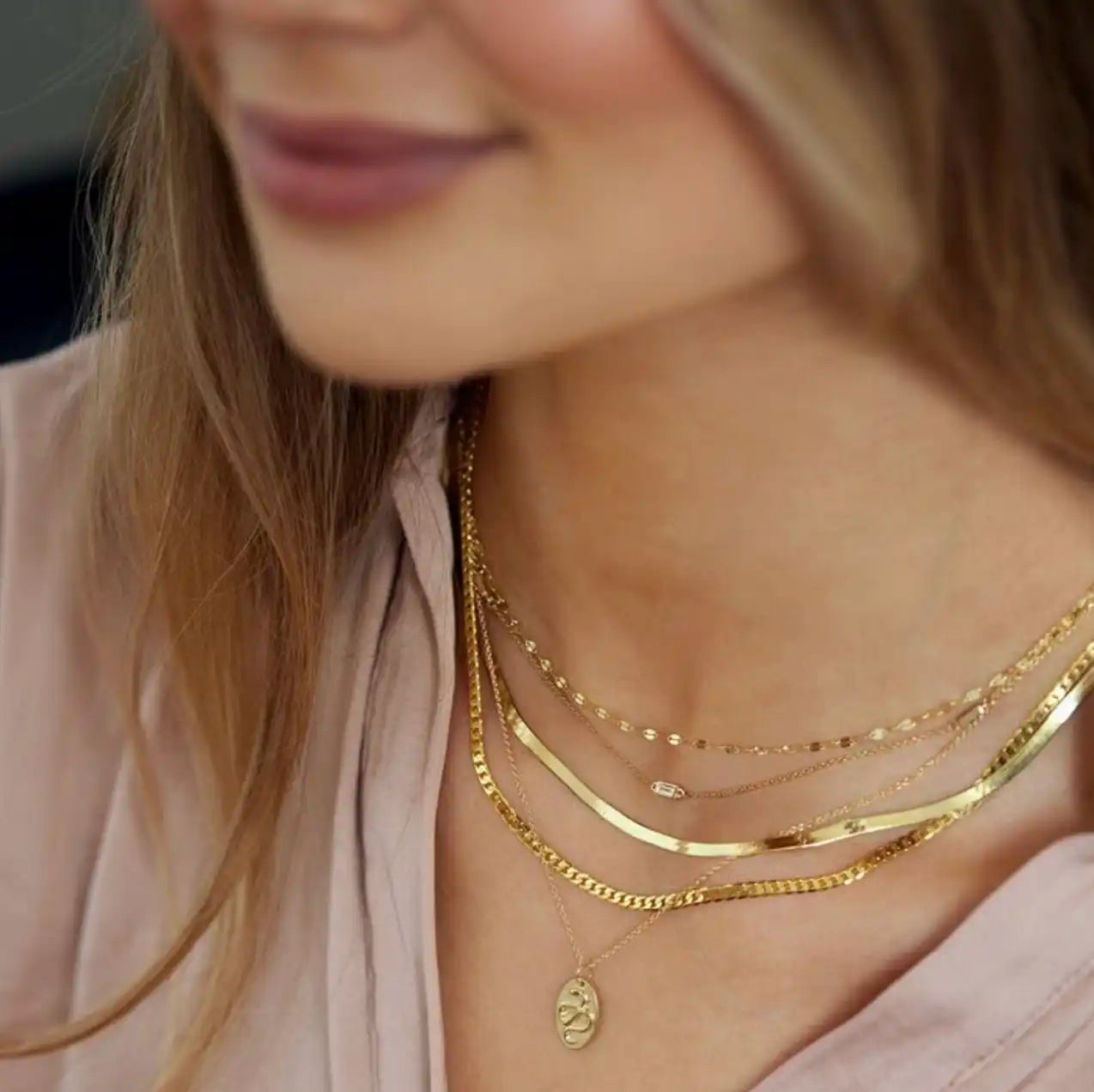 Layered gold necklaces styles on a model