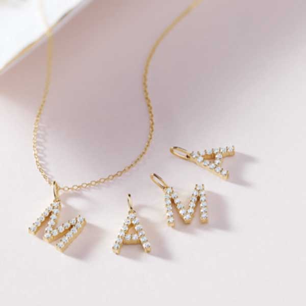 Personalized Mother’s Day necklace stacked with custom diamond initial charms