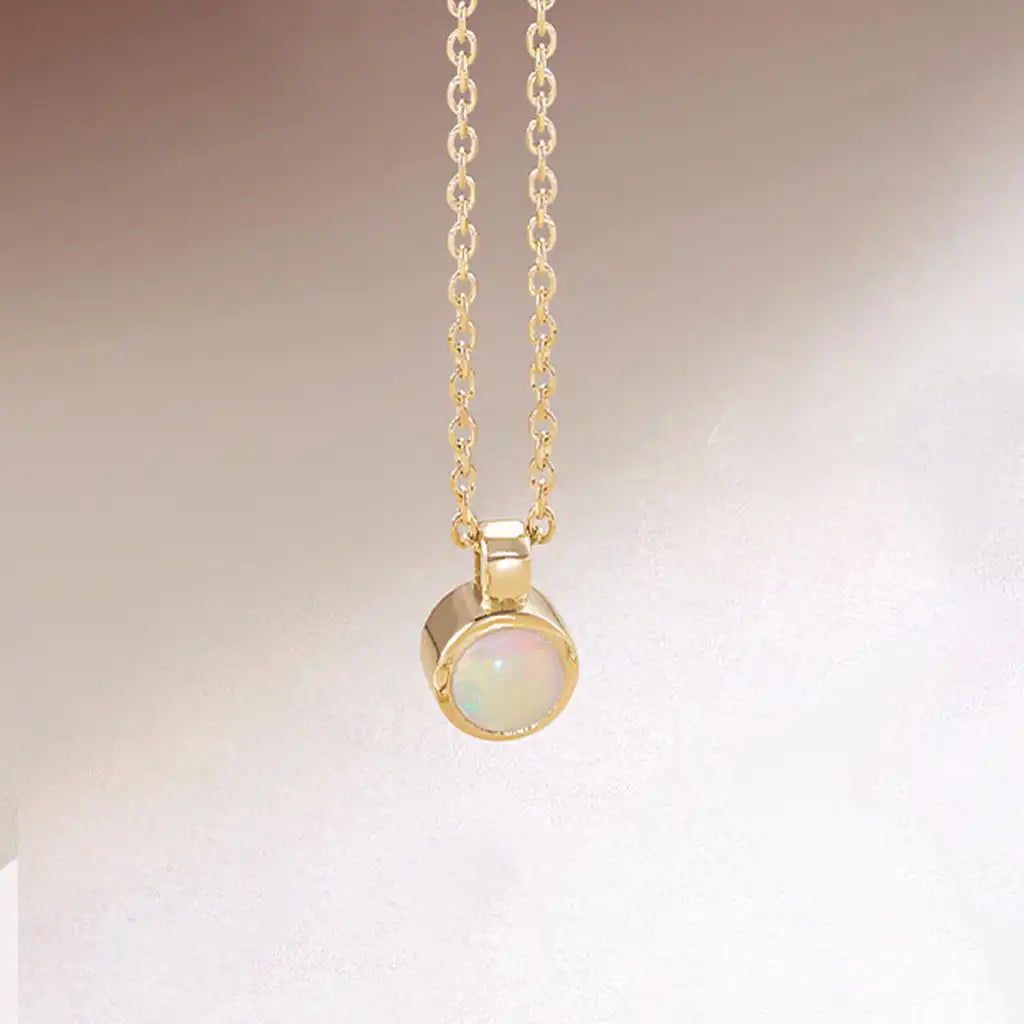 Opal pendant necklace bezel-set in 14K gold, handcrafted in Colorado