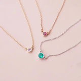 Bezel-set birthstone necklaces arranged