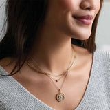 Bezel-set birthstone necklaces shown on model