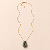 Labradorite long pendant necklace, hand-cut briolette on an adjustable rolo chain, flat lay