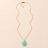 Chalcedony long pendant necklace, hand-cut briolette on an adjustable rolo chain, flat lay