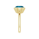 11x9mm oval topaz ring with deep London blue stone in east-west gold setting