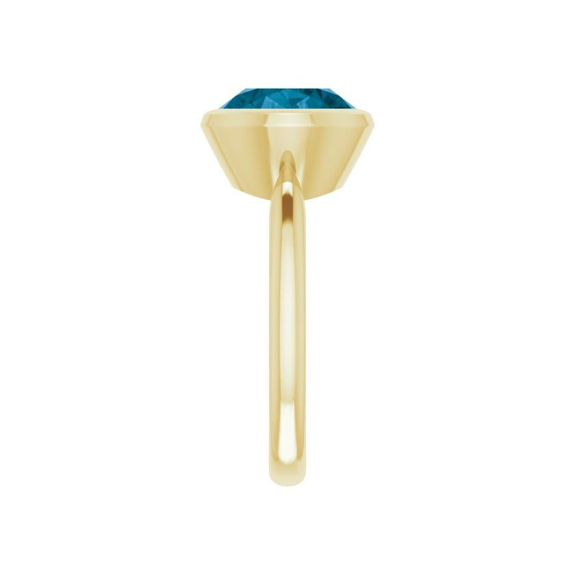 Ethical 10K gold ring with deep blue London topaz in east-west bezel setting
