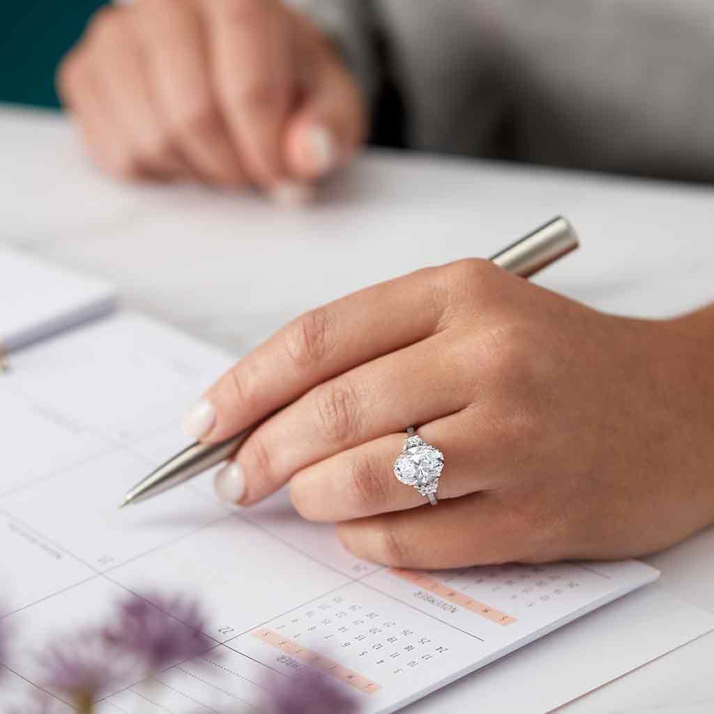 Three-stone half-moon engagement ring in 14K gold, diamond center, side profile