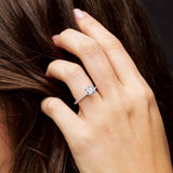 Round Diamond Claw Prong accented engagement ring shown on hand